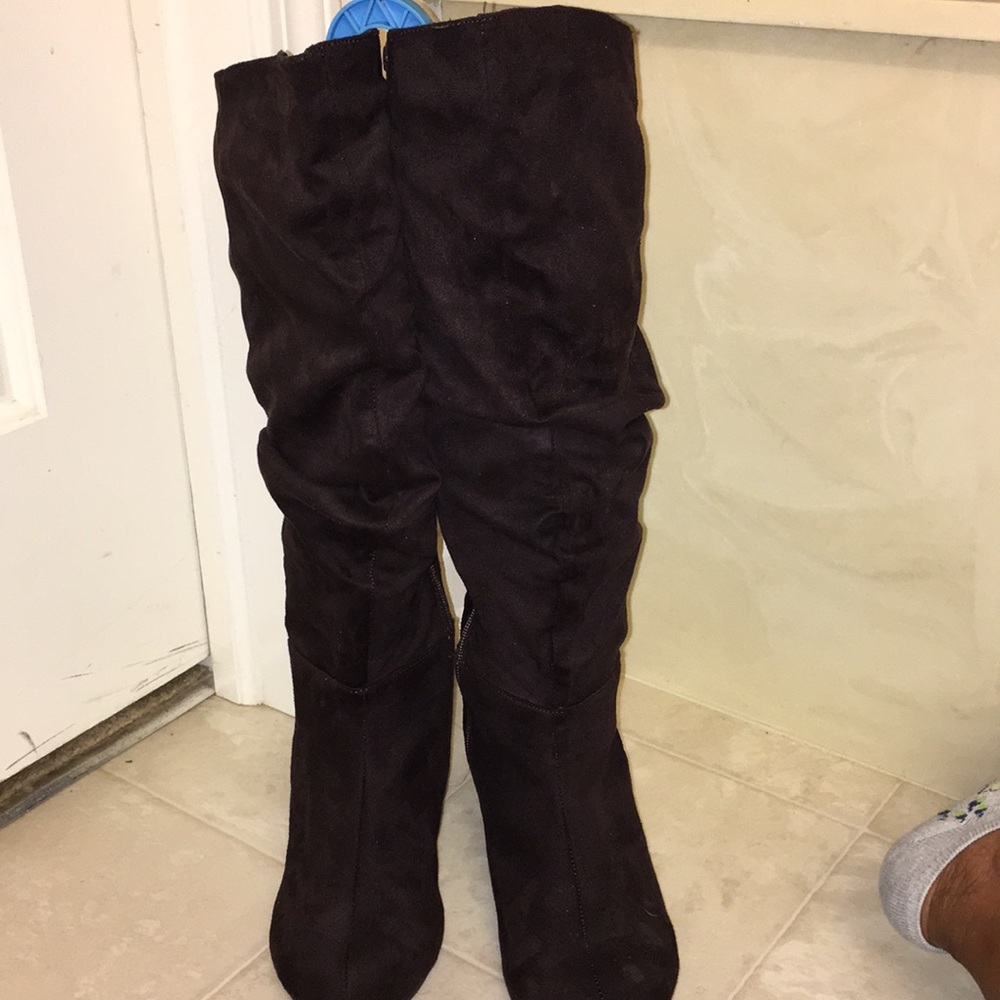 black suede tall boots with a small wedge heel